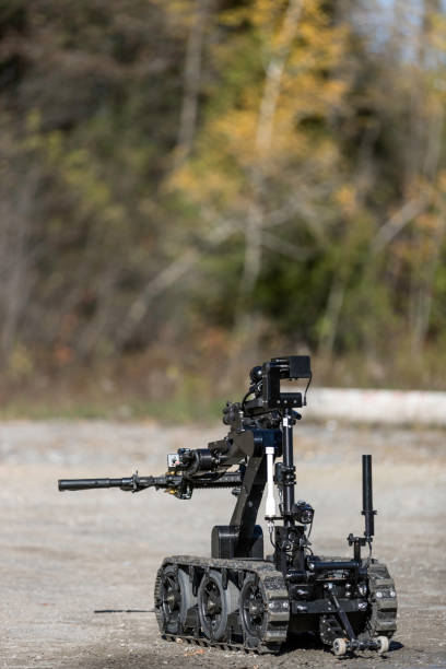 istock Police Swat Officer Using a Mechanical Arm Bomb Disposal Robot Unit 925123698