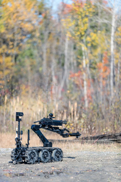 istock Police Swat Officer Using a Mechanical Arm Bomb Disposal Robot Unit 925123704