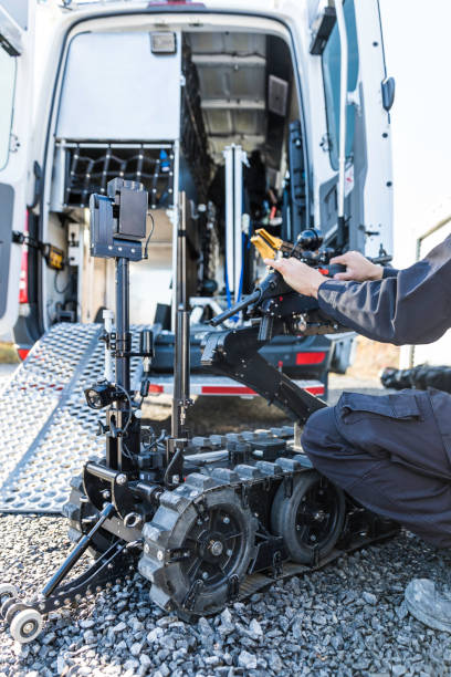 istock Police Swat Officer Using a Mechanical Arm Bomb Disposal Robot Unit 925123726