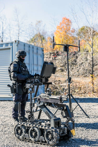istock Police Swat Officer Using a Mechanical Arm Bomb Disposal Robot Unit 925123752