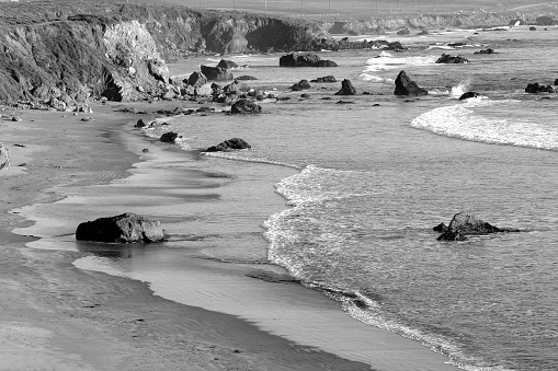 The rocky coastline of big sur California (specifically, Piedras Blancas).  Black and white.