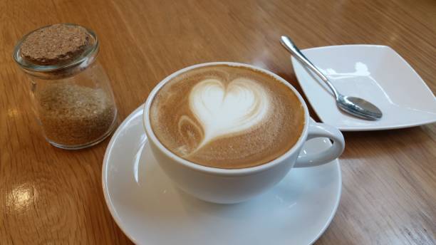 istock Morning Latte Coffee Cup with Heart on Cafe Table 925133760