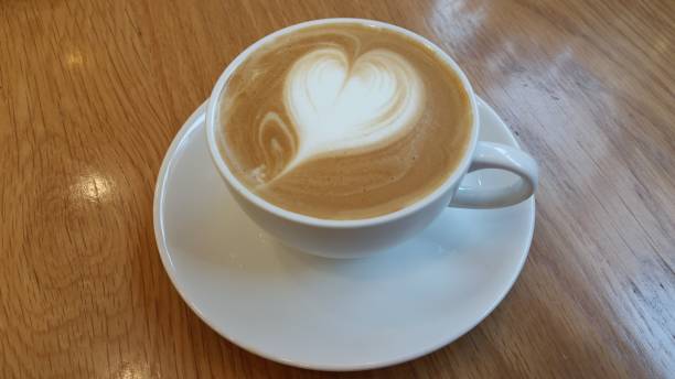 istock Morning Latte Coffee Cup with Heart on Cafe Table 925134062