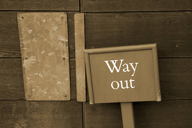 сепия way out-знак выход - go английское слово стоковые фото и изображения
