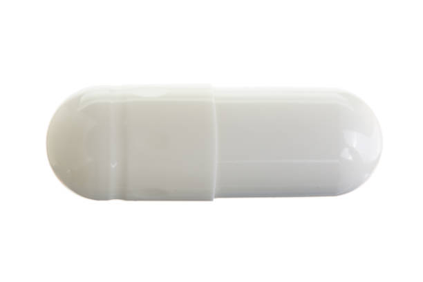 istock white pill capsule isolated on white background macro. Top view 925143754