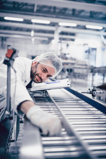 istock Scientist Writing on Clipboard and Working on Production Line 925145396