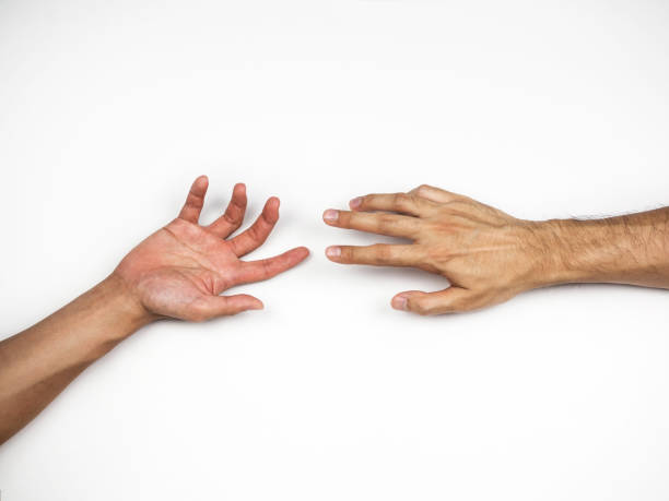 istock Hands reaching to each other on white background 925148056