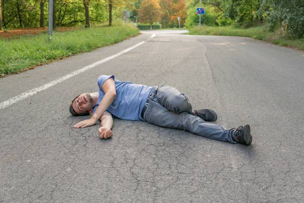 istock Injured man had an accident and is lying on road. 925159304