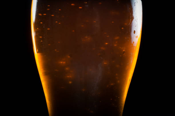 beer in glass on black background