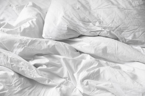 istock Top view. Close up unmade white bedding sheets and pillow, Messy bed after night sleep concept. textile background. illustration of a romantic date at a hotel, cheating 925159530