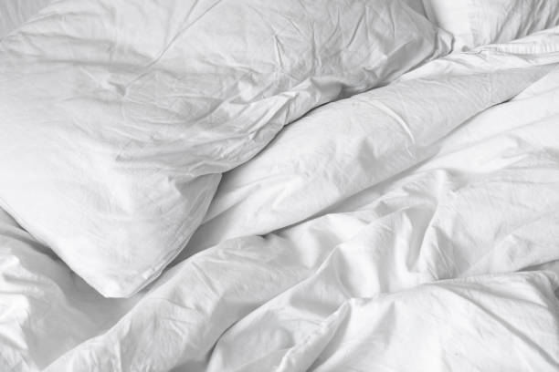 istock Top view. Close up unmade white bedding sheets and pillow, Messy bed after night sleep concept. textile background. illustration of a romantic date at a hotel, cheating 925159554