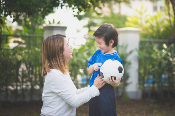 istock Asian mother and son Playing Soccer 925163312