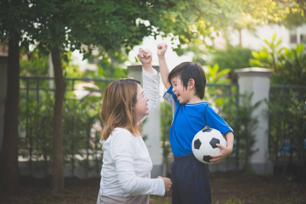 istock Asian mother and son Playing Soccer 925163318