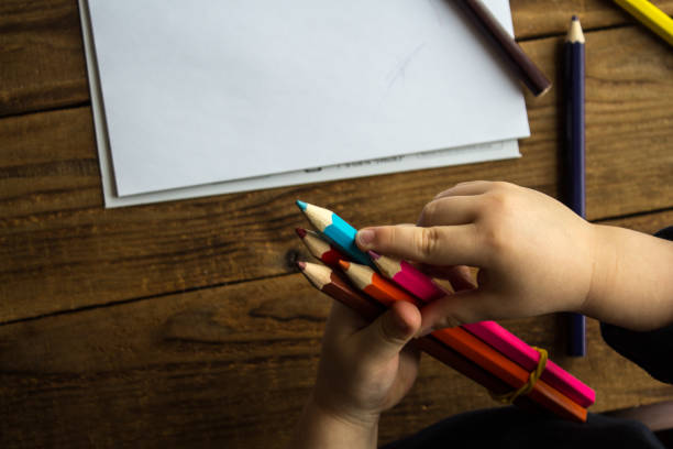 istock little boy holds colored pencils 925163888