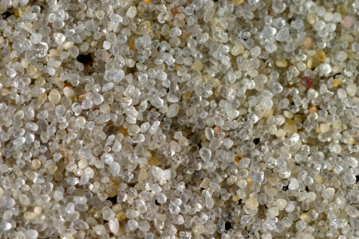 An extreme closeup of sand grains on a beach in New Jersey.  You can see the detail and coloration in each grain.