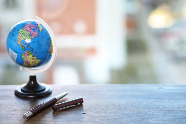 istock A pen on the desk and a small globe 925168088