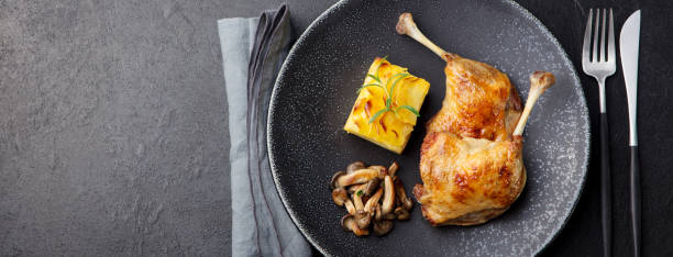 istock Duck legs confit with potato gratin and mushroom sauce . Restaurant serving. 925170790