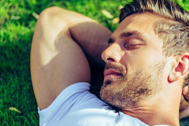 istock Close up of a handsome man resting in his backyard. 925171628