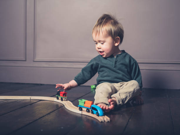 istock Cute little boy playing with wooden train 925171944