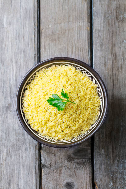 istock Couscous in bowl. Wooden background. Top view. Copy space. 925172336