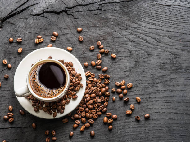 istock Cup of coffee surrounded by coffee beans. 925175650