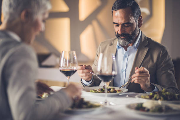 istock Senior couple eating dinner in a restaurant. 925180260
