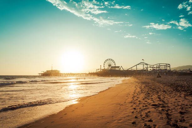 Amusement park in Santa Monica Sunset in Santa Monica, view on the amusement park ferris wheel photos stock pictures, royalty-free photos & images