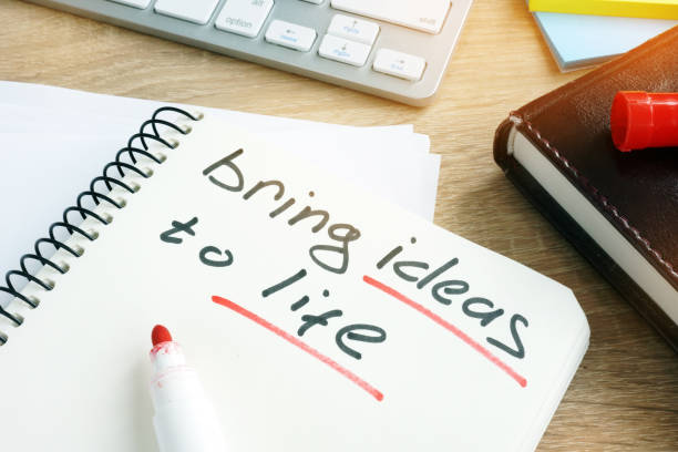 istock Bring ideas to life written in a note. 925184942