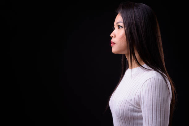 istock Beautiful Asian woman against black background 925185228