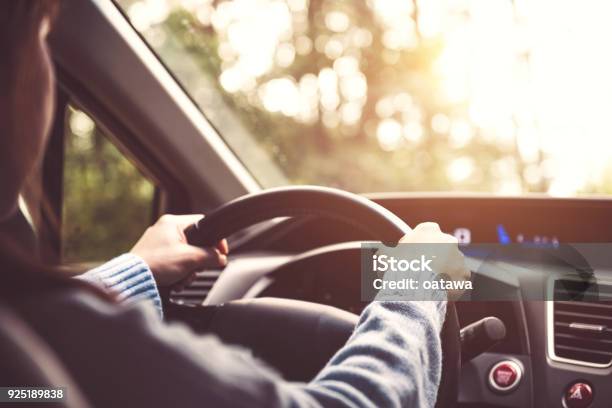 Woman Driving Car At Sunny Stock Photo - Download Image Now - Driving, Car, Steering Wheel