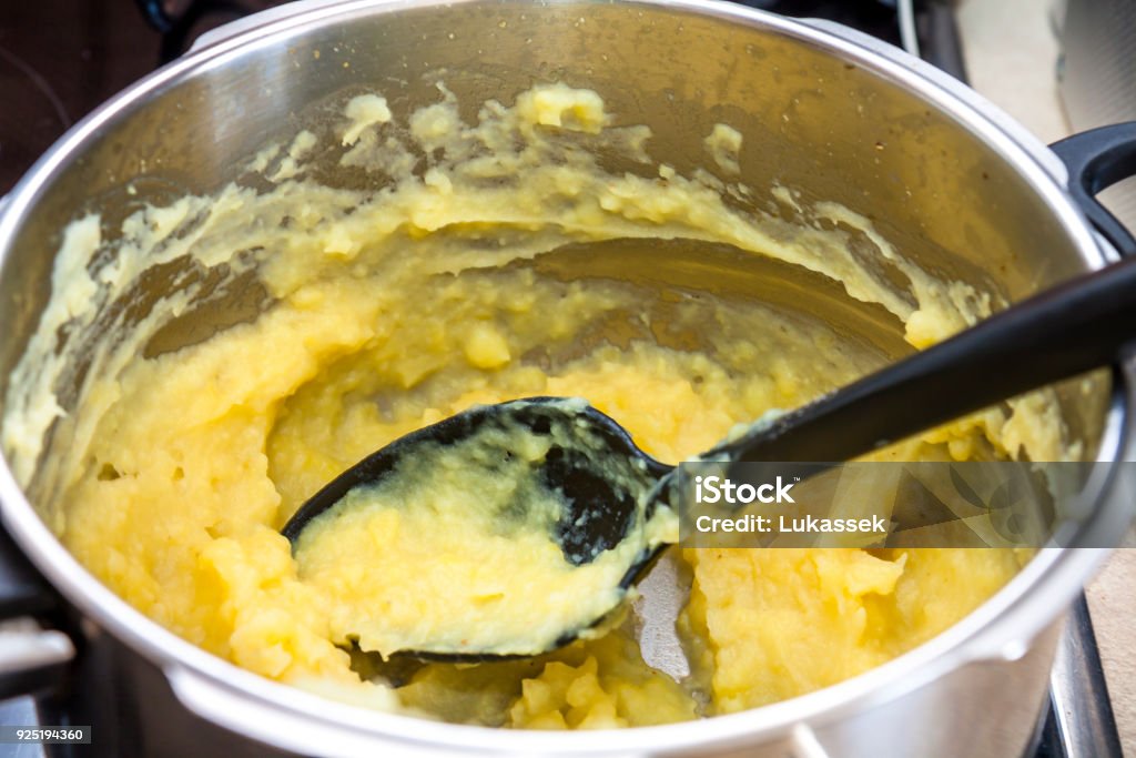Mashed potatoes in a big pot Mashed potatoes in a big pot with spoon Basil Stock Photo