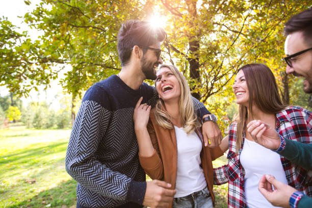 istock Group of young people walking through park 925196502