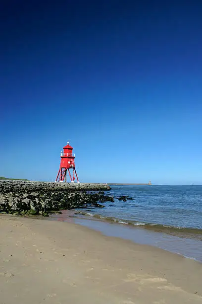 southsheilds coastal landmark of an old lighthouse on the  groyne pier.