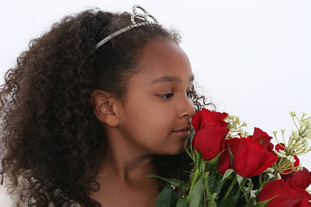 Beautiful Little Princess With Tiara Smelling Roses Over White  princess crown tiara prom stock pictures, royalty-free photos & images