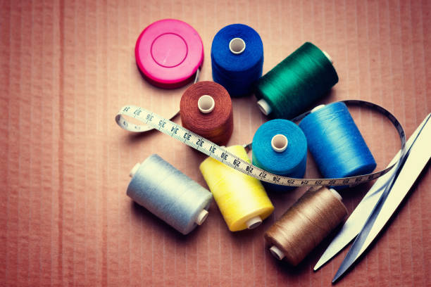 istock Pile of colorful spools of thread, scissors and measuring meter 925199804
