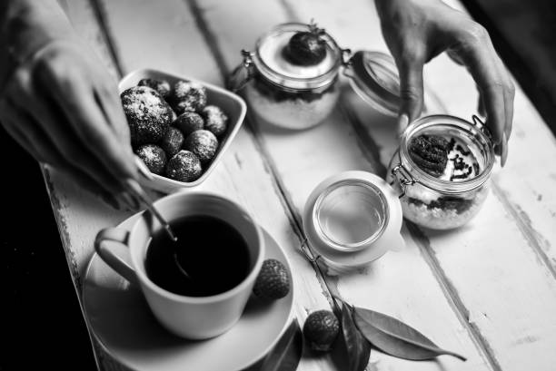 Strawberry cheesecake dessert in a jar on the table black and white poster