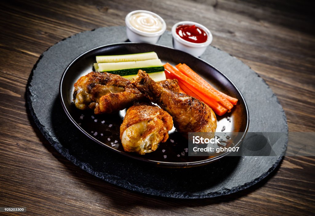 Roast chicken drumsticks with baked potatoes Roast chicken legs with baked potatoes Dieting Stock Photo