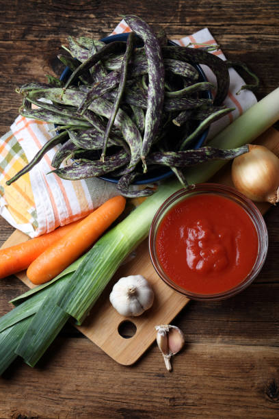 istock Beans, leeks, onions, garlic, carrots and tomato sauce on the table 925203794