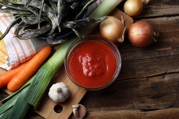 istock Beans, leeks, onions, garlic, carrots and tomato sauce on the table 925206020