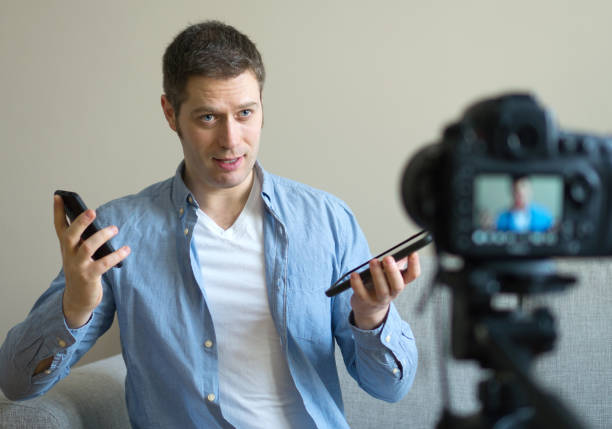 istock Handsome man making video blog about mobile phones. 925207890