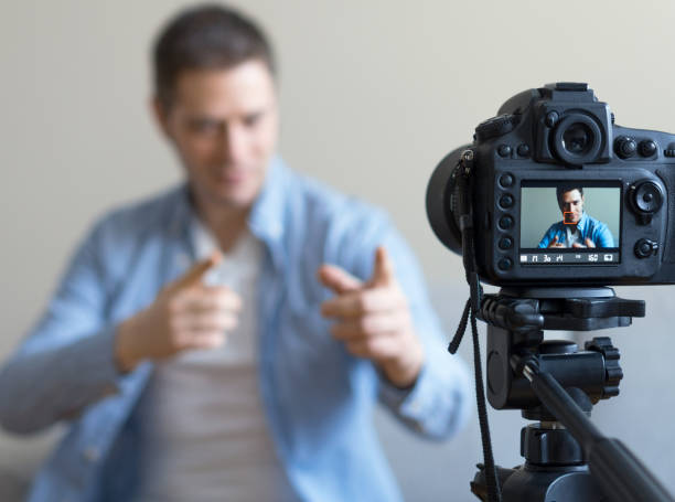 istock Handsome man making video blog. Focus on camera. 925207938