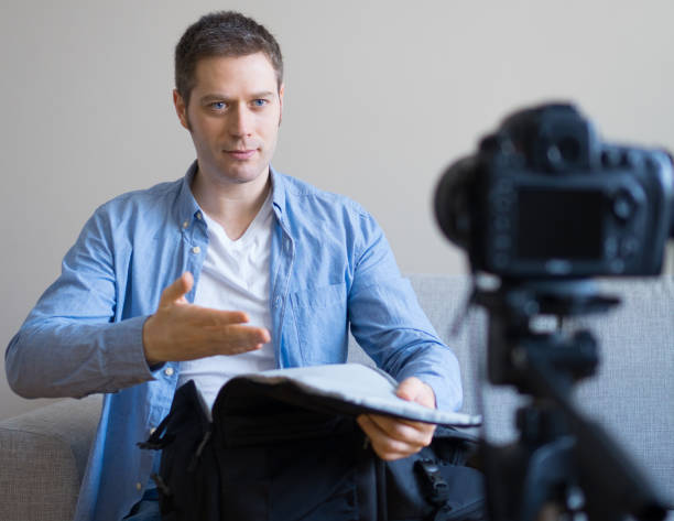 istock Handsome man making video blog about travel backpack. 925207940