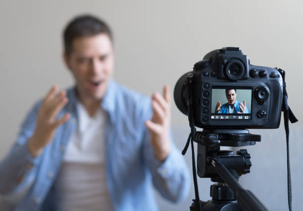 istock Handsome man making video blog. Focus on camera. 925207944