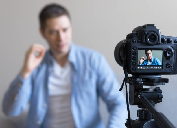 istock Handsome man making video blog. Focus on camera. 925207956