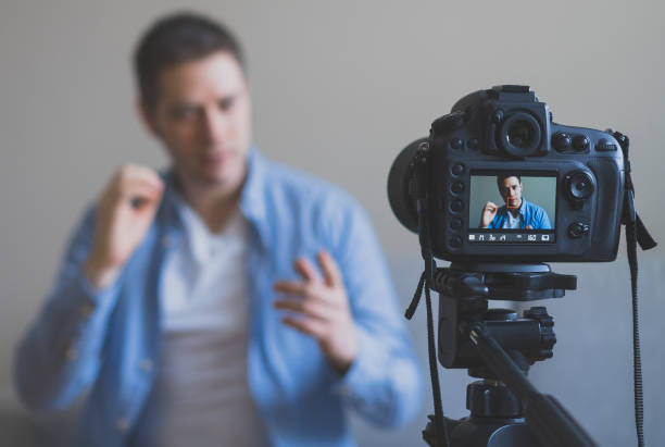 istock Handsome man making video blog. Focus on camera. 925207960