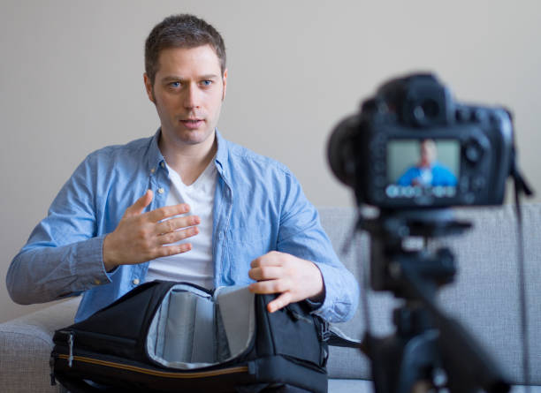 istock Handsome man making video blog about travel backpack. 925207966