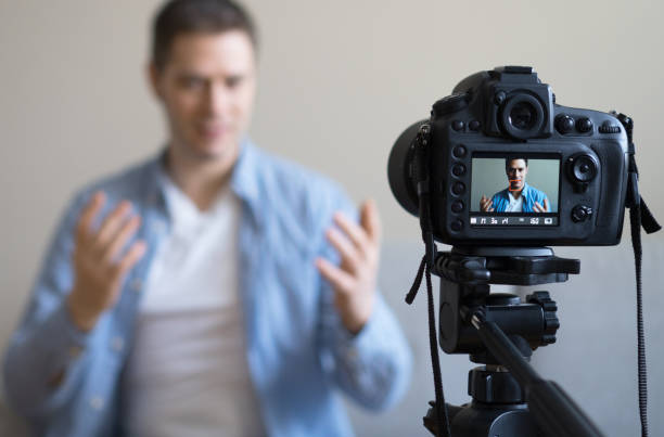 istock Handsome man making video blog. Focus on camera. 925207976