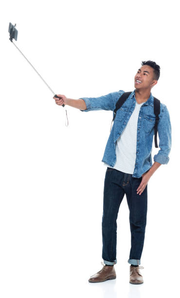 istock Attractive young male holding a selfie stick 925211546