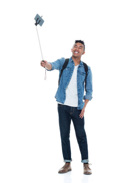 istock Attractive young male holding a selfie stick 925211548