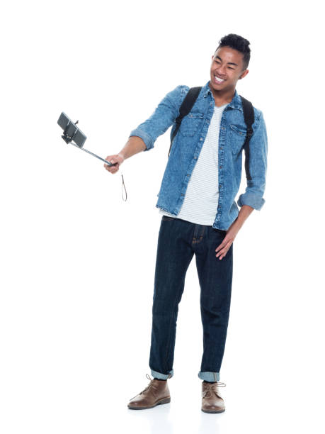 istock Attractive young male holding a selfie stick 925211550